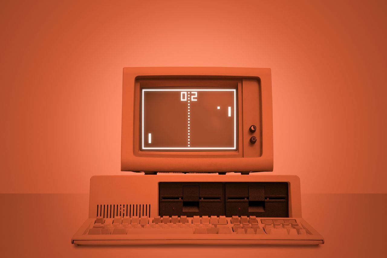 Vintage tennis videogame on old computer monitor with coloured brown background. Retro revival of seventies devices. Copy space. Low-key background for easy costumization.