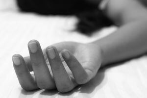 Picture of a numb hand of a woman showing death or unconsciousness