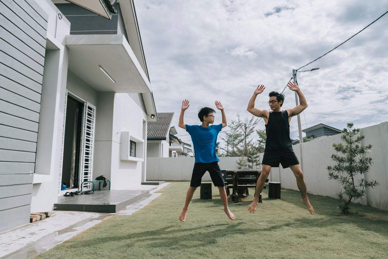 father and son exercising at home