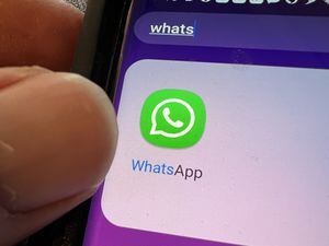Close-up of icon for Whatsapp messaging app on cellphone, Lafayette, California, with person's hand visible, February 28, 2022. Photo courtesy Tech Trends. (Photo by Gado/Getty Images)