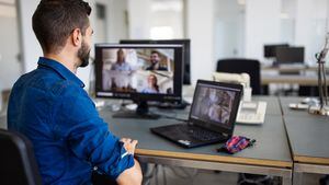 Videoconferencia de empresario con equipo en computadora. Joven discutiendo los detalles del proyecto con el equipo a través de una videollamada.