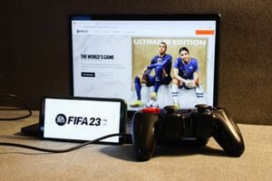 FIFA 23 website displayed on a laptop screen, FIFA 23 logo displayed on a phone screen and a gamepad are seen in this illustration photo taken in Krakow, Poland on August 23, 2022. (Photo by Jakub Porzycki/NurPhoto via Getty Images)