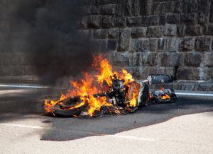 a motorcycle has caught fire after an accident and burns out completely