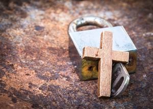 image of the metal lock and key with wooden cross on old rusty metal background can use for christian symbol show meaning Jesus is the key to heaven or the key to solve the spiritual problem