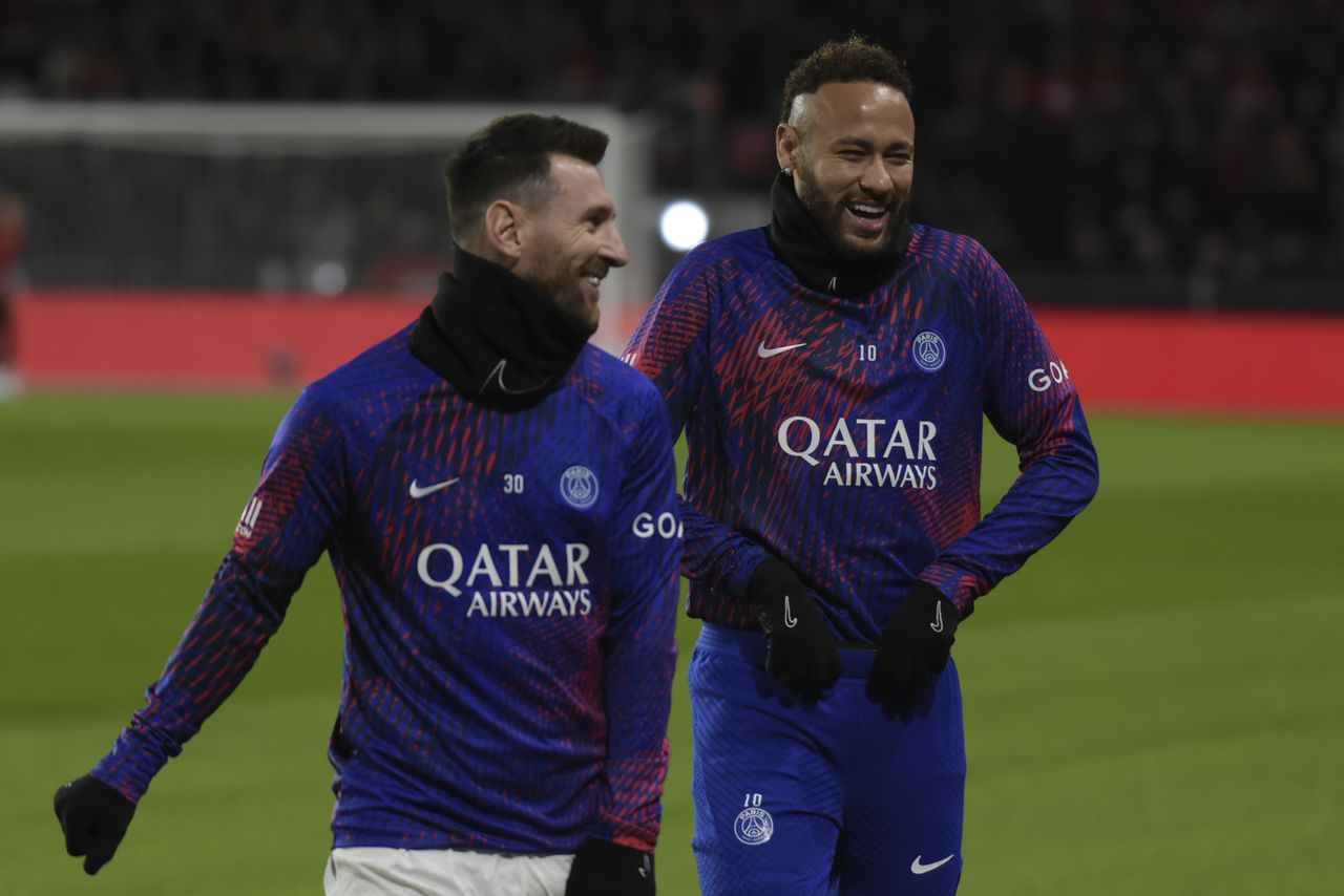 PSG's Lionel Messi, left, shares a laugh with PSG's Neymar as they warm up before the League One soccer match Rennes against Paris Saint-Germain at the Roazhon Park stadium Sunday, Jan. 15, 2023 in Rennes, western France. (AP Photo/Mathieu Pattier)