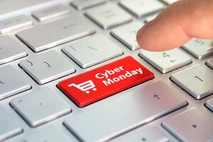 Cyber Monday on key board. shopping enter button key on keyboard. Color button on the gray silver keyboard of modern ultrabook. caption on the button.