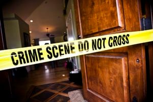 Crime Scene tape at the front door of a luxury home