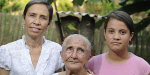 Judith, Emilia y Carolina están convencidas de que las figuras que aparecieron en esta hoja de plátano, en el jardín de su casa, son la Virgen del Carmen y el Sagrado Corazón de Jesús. Fotos Camilo Rozo.