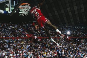 UNDATED: Chicago Bulls' forward Michael Jordan #23 dunks as the crowd takes photos during a game against the Portland Trail Blazers circa 1984-1998. (Photo by Focus on Sport via Getty Images)