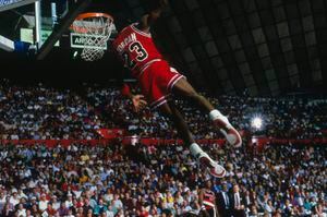 UNDATED: Chicago Bulls' forward Michael Jordan #23 dunks as the crowd takes photos during a game against the Portland Trail Blazers circa 1984-1998. (Photo by Focus on Sport via Getty Images)