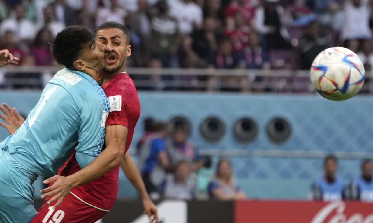 Iran's goalkeeper Alireza Beiranvand collides with Iran's Majid Hosseini, right, during the World Cup group B soccer match between England and Iran at the Khalifa International Stadium in Doha, Qatar, Monday, Nov. 21, 2022. (AP/Alessandra Tarantino)