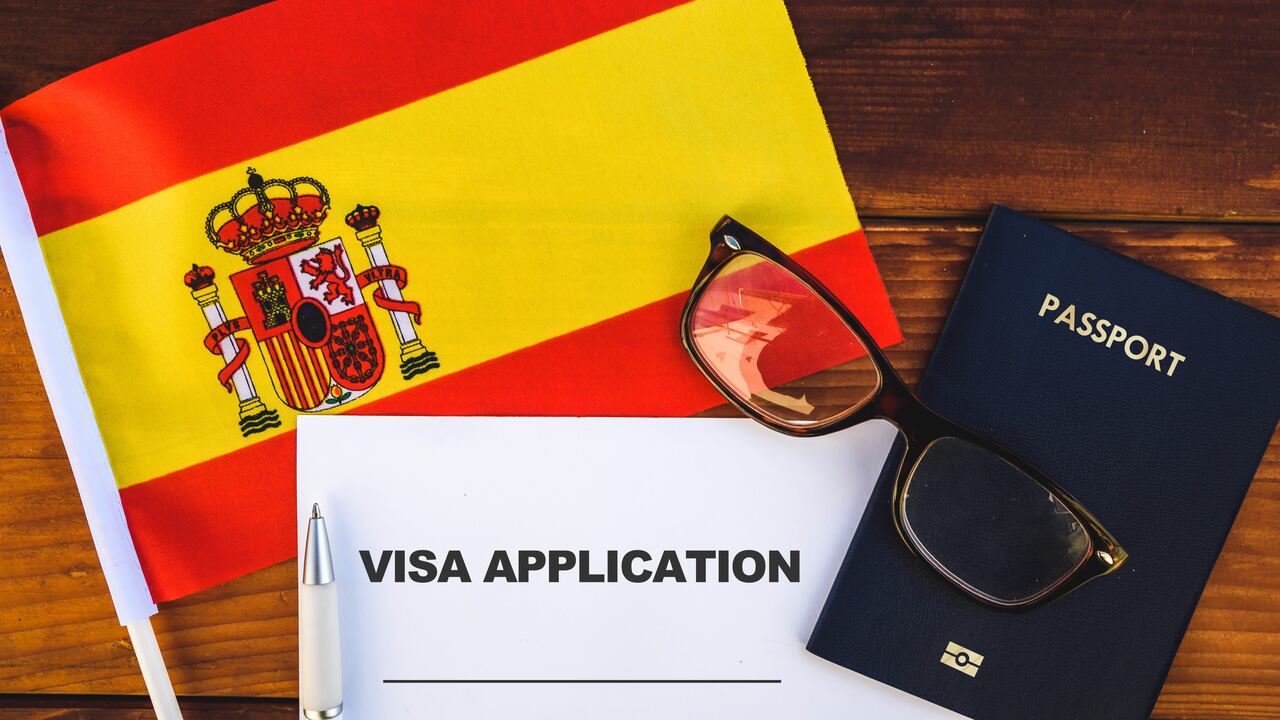 Flag of Spain , visa application form and passport on table