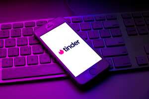 SPAIN - 2021/10/13: In this photo illustration a Tinder logo seen displayed on a smartphone on top of a computer keyboard. (Photo Illustration by Thiago Prudêncio/SOPA Images/LightRocket via Getty Images)