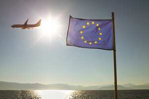 Europa European Union Flag Against Sun & Sea With Plane