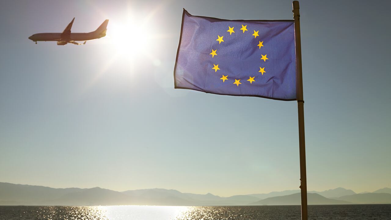 Europa European Union Flag Against Sun & Sea With Plane