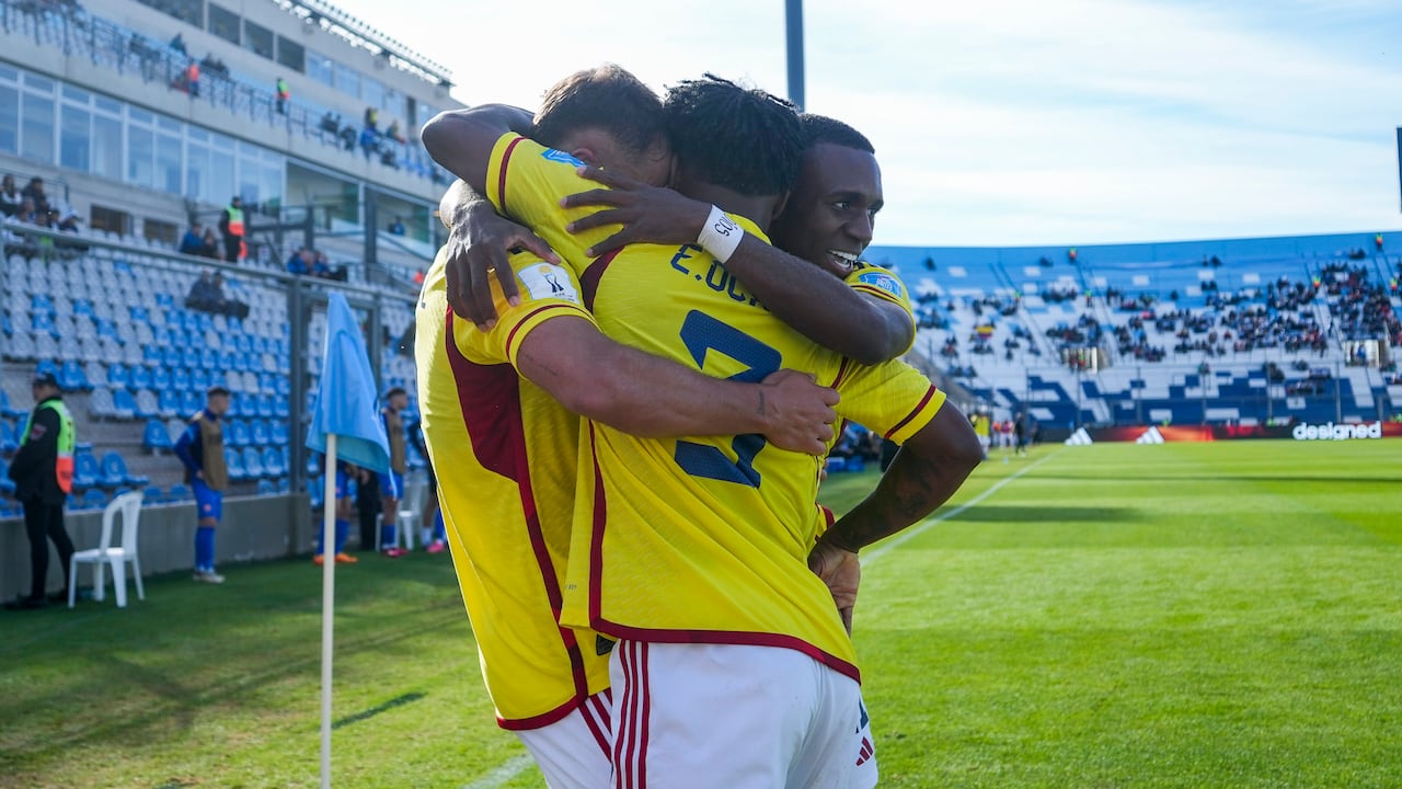 Colombia's Tomas Angel, left, is congratulated after scoring his side's 4th goal against Slovakia during a FIFA U-20 World Cup round of 16 soccer match at the Bicentenario stadium in San Juan, Argentina, Wednesday, May 31, 2023. (AP Photo/Ricardo Mazalan)