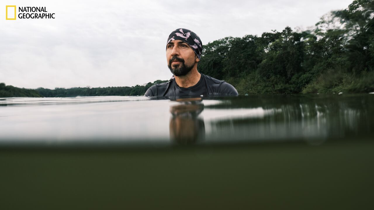 Laguna Damas del Norte, Guaviare, Colombia - 2022/03/04: Fernando Trujillo watches for pink dolphins or Toninas at dawn in Laguna Damas de Nare.