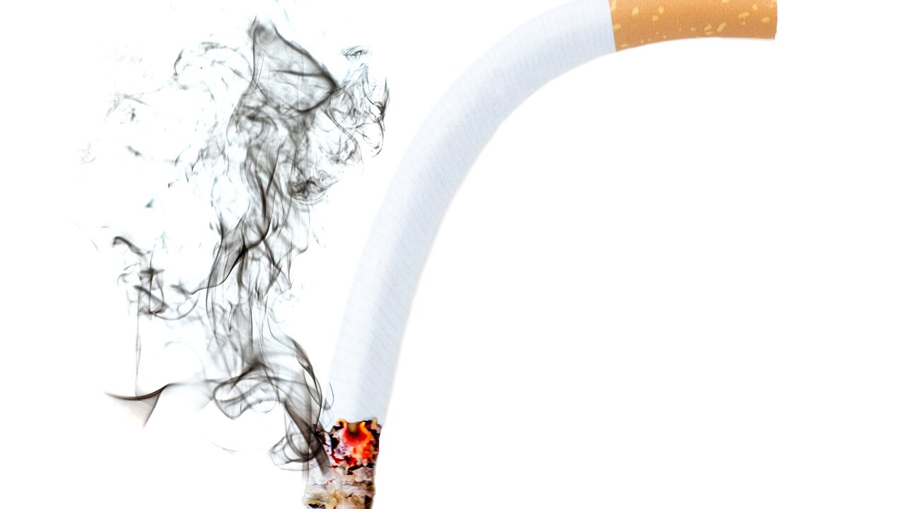 Close up of a cigarette bend with smoke showing at white background, Erectile Dysfunction concept
