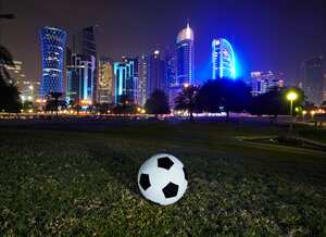 Football and skyline of the West Bay Doha. Qatar is set to stage the 2022 world cup football tournament, the first Middle east country to do so.