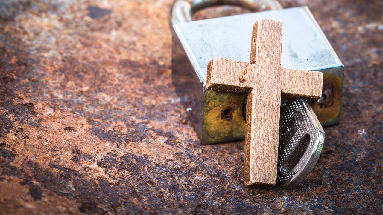 image of the metal lock and key with wooden cross on old rusty metal background can use for christian symbol show meaning Jesus is the key to heaven or the key to solve the spiritual problem