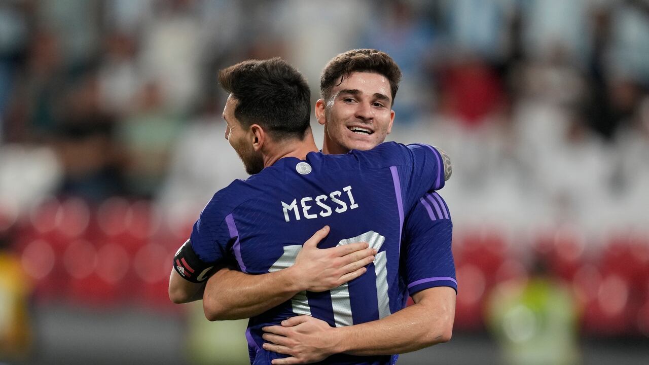 Argentina's Julian Alvarez and Lionel Messi celebrate after he scored during a friendly soccer match between Argentina and United Arab Emirates in Abu Dhabi, Wednesday, Nov. 16, 2022. (AP Photo/Kamran Jebreili)