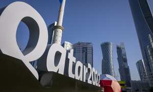FILE - Branding is displayed near the Doha Exhibition and Convention Center in Doha, Qatar, Thursday, March 31, 2022. Qatar’s ruling emir has lashed out at criticism of the country over its hosting of the 2022 FIFA World Cup, complaining of an “unprecedented campaign” targeting the first Arab nation to hold the tournament. (AP Photo/Darko Bandic, File)