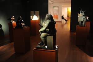 BOGOTA, COLOMBIA - DECEMBER 5, 2009: People visit Fernando Botero museum in Bogota where a wide selection of his paintings and sculputers donated to the museum by the artist himself are on permanent display. Harmoniously housed in the heart of Bogota, Botero Museum showcases the works of Colombia's national treasure - Fernando Botero. The museum displays an electric array of paintings which reveal qualities of skill, humor, satire and whimsicality Fernando Botero's series on "fat people". Botero himself oversaw every aspect of its construction, which was one of the conditions of his bequest. Another was that it should be free. He also chose the building, the colour scheme, the lighting and the arrangement of the works. As well as 123 of his own paintings, including his take on famous works like the Mona Lisa, he donated 85 pieces by other artists showing that Botero must have made a few dollars in his time. Fernando Botero Angulo (born April 19,1932) is a Colombian figurative artist, self-titled "the most Colombian of Colombian artists" early on, coming to prominence when he won the first prize at the Salón de Artistas Colombianos in 1958. (Photo by Kaveh Kazemi/Getty Images)