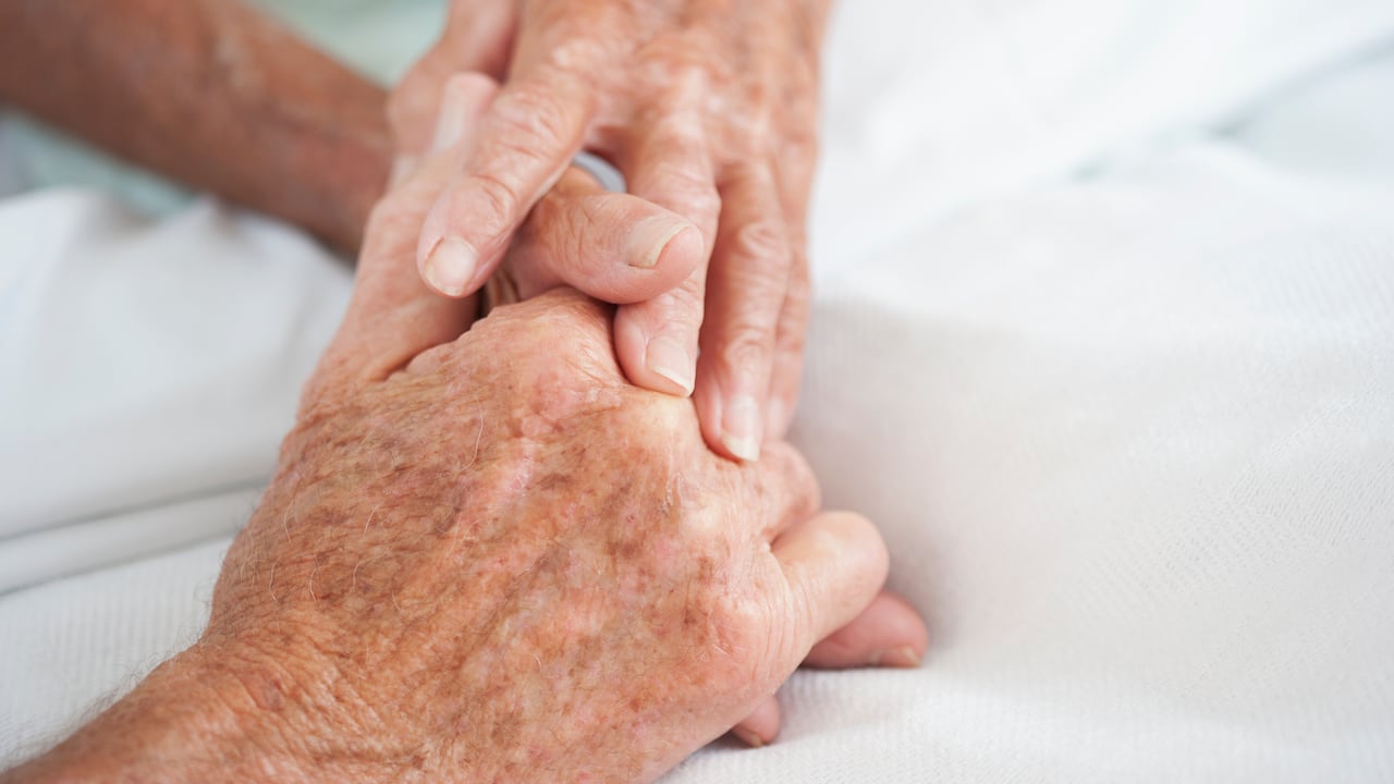 Husband comforting wife in hospital bed