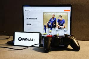 FIFA 23 website displayed on a laptop screen, FIFA 23 logo displayed on a phone screen and a gamepad are seen in this illustration photo taken in Krakow, Poland on August 23, 2022. (Photo by Jakub Porzycki/NurPhoto via Getty Images)