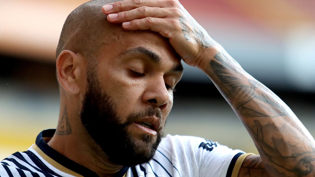 (FILES) In this file photo taken on September 4, 2022 Pumas' Brazilian defender Dani Alves gestures during the Mexican Apertura tournament football match against Atlas at the Jalisco stadium in Guadalajara, Jalisco State, Mexico. - Former Brazil defender Dani Alves was taken into custody on January 20, 2023 in Spain over allegations that he sexually assualted a woman at a Barcelona nightclub in December, police said. The 39-year-old player was summoned to a Barcelona police station where he was "taken into custody" and will now be questioned by a judge, said a spokesman for Catalonia's regional police force, the Mossos d'Esquadra. (Photo by Ulises Ruiz / AFP)