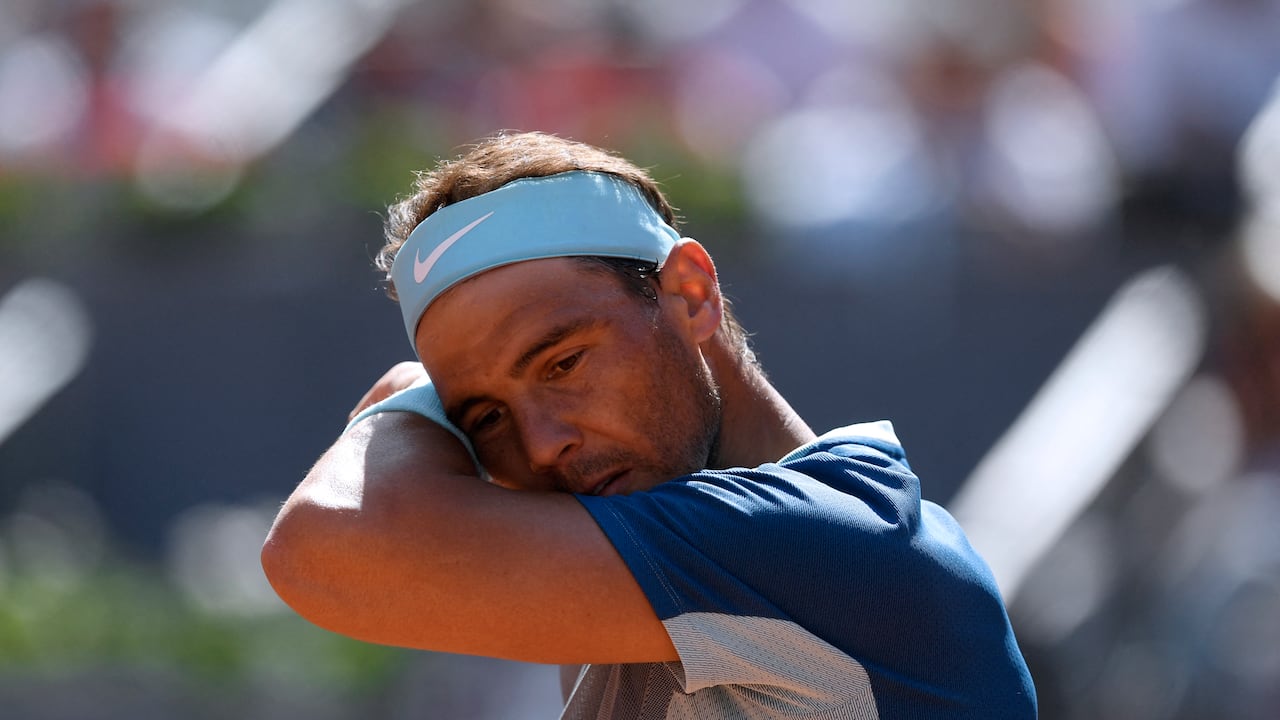Spain's Rafael Nadal wipes his face as he competes against Spain's Carlos Alcaraz during their 2022 ATP Tour Madrid Open tennis tournament singles quarter-final match at the Caja Magica in Madrid on May 6, 2022. (Photo by OSCAR DEL POZO / AFP)