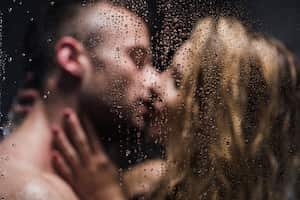 Blurred image of a sexy pair kissing in the shower