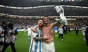 LUSAIL CITY, QATAR - DECEMBER 18: Lionel Messi and Rodrigo De Paul of Argentina celebrate with the fans after the team's victory in the penalty shoot out during the FIFA World Cup Qatar 2022 Final match between Argentina and France at Lusail Stadium on December 18, 2022 in Lusail City, Qatar. (Photo by Shaun Botterill - FIFA/FIFA via Getty Images)
