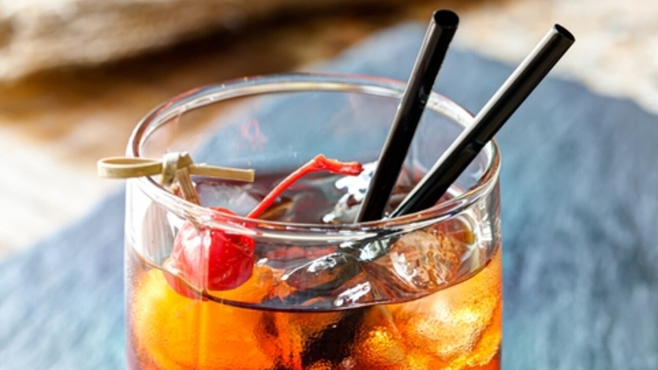 Glass of beautiful alcoholic cocktails with ice and cherry