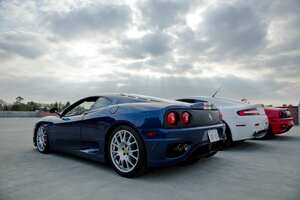 Cerritos, CA, USA - March 14, 2009:  A red Ferrari 360 Modena, Aston Martin V8 Vantage, and Ferrari 360 Challenge Stradale sports cars in Cerritos, CA on March 14, 2009. All three cars are powered by V8 engines.