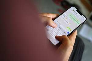 ILLUSTRATION - 06 July 2022, Bavaria, Augsburg: A young man types a WhatsApp message on a smartphone. Voice messages, on the other hand, cause frustration for some recipients. Others are happy about the personal message. (to dpa "Not another voice message?") Photo: Karl-Josef Hildenbrand/dpa (Photo by Karl-Josef Hildenbrand/picture alliance via Getty Images)