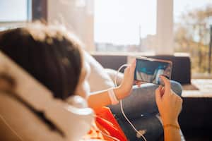 Woman using a smarthome app sunlight in an appartment.