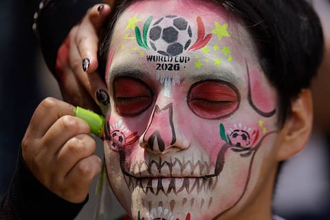 A makeup session takes place during the Catrinas World Cup Parade, which departs from the Angel of Independence and proceeds to the Palace of Fine Arts in Mexico City, on March 22, 2026. The event occurs on the eve of the 2026 World Cup, scheduled to be held on June 11. (Photo by Gerardo Vieyra/NurPhoto via Getty Images)