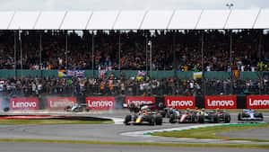 NORTHAMPTON, ENGLAND - JULY 03: Max Verstappen of the Netherlands driving the (1) Oracle Red Bull Racing RB18 leads Carlos Sainz of Spain driving (55) the Ferrari F1-75 and the rest of the field out of turn one as Zhou Guanyu of China driving the (24) Alfa Romeo F1 C42 Ferrari and George Russell of Great Britain driving the (63) Mercedes AMG Petronas F1 Team W13 crash at the start during the F1 Grand Prix of Great Britain at Silverstone on July 03, 2022 in Northampton, England. (Photo by Rudy Carezzevoli - Formula 1/Formula 1 via Getty Images)
